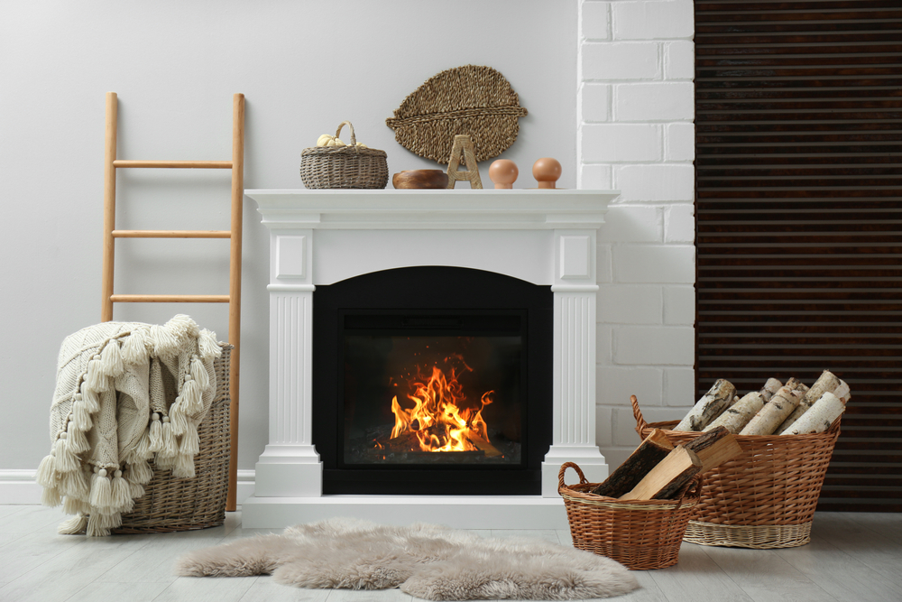 Wicker,baskets,with,firewood,and,white,fireplace,in,cozy,living